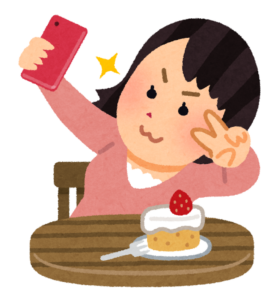 スマートフォンで自撮りをする女性のイラスト