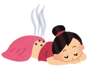背中にお灸をすえてもらう女性